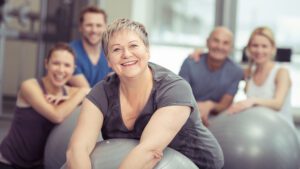 smiling-senior-woman-enjoying-pilates-class